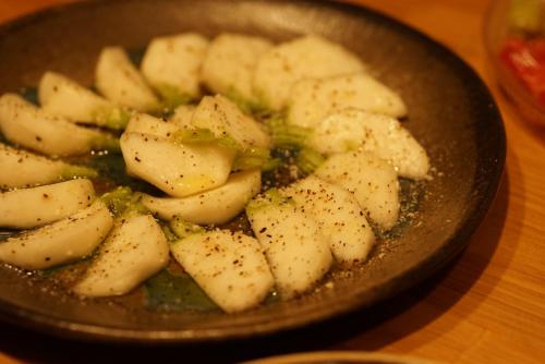 a pan filled with potatoes and broccoli on a table at björk （森の宿 ビヨルク） in Myoko