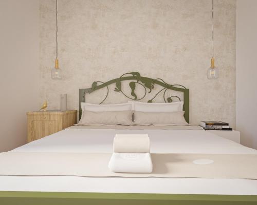 a bedroom with a white bed with a metal headboard at Vila Perast Boutique Hotel in Perast