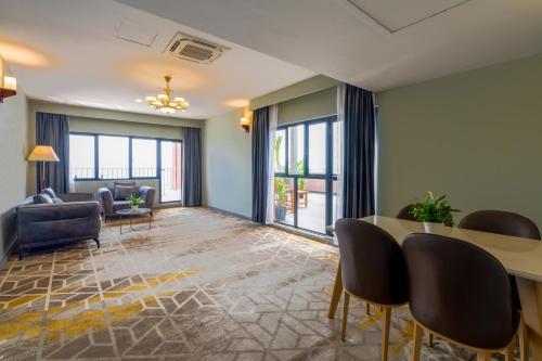 a living room with a table and chairs at Manhattan Business Hotel, Male in Male City
