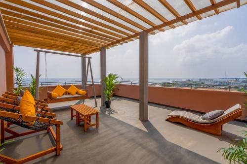 a balcony with chairs and a view of the ocean at Manhattan Business Hotel, Male in Male City