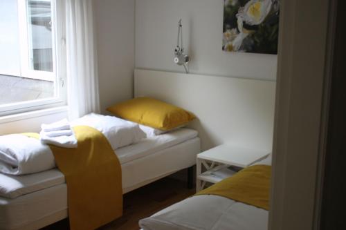 a small room with a bed and a window at Skarrildhus Sinatur Hotel & Konference in Skarrild