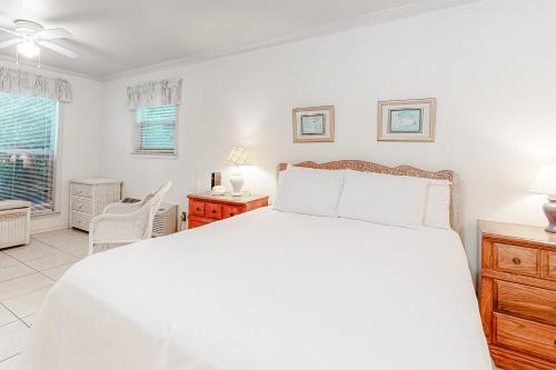 a white bedroom with a bed and a desk at Campbellot by Meyer Vacation Rentals in Fort Morgan