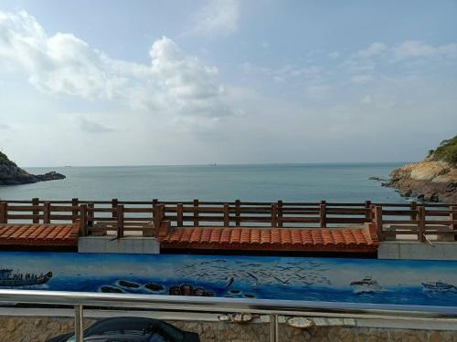 a view of the ocean with a fence and the water at 津沙堤岸 in Nangan