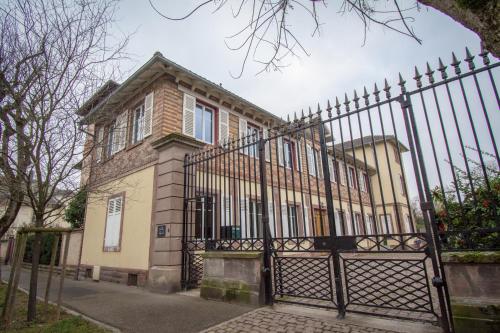 an old house with a wrought iron fence at Gite Villa Avril piscine- jacuzzi- sauna - 15 Pers-proche Europapark in Sélestat
