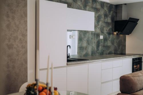 a kitchen with a sink and a counter with fruit at Central Apartment Chunarot in Ohrid