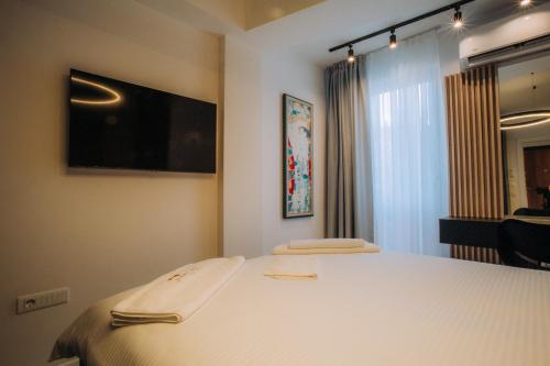 a bedroom with a bed with two towels on it at Central Apartment Chunarot in Ohrid