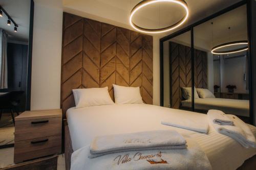 a bedroom with a large white bed with a large mirror at Central Apartment Chunarot in Ohrid