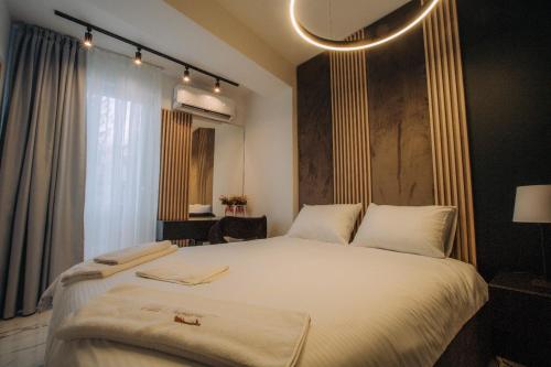 a bedroom with a large bed with white sheets at Central Apartment Chunarot in Ohrid