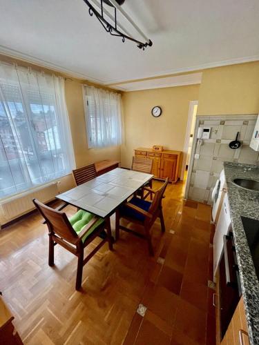 a kitchen with a table and chairs in a room at Apartamento Parque del Oeste in Oviedo