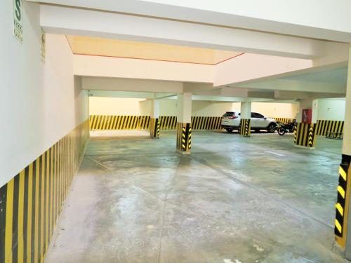 an empty parking garage with a car parked in it at HOTEL ESTRELLA in Lima