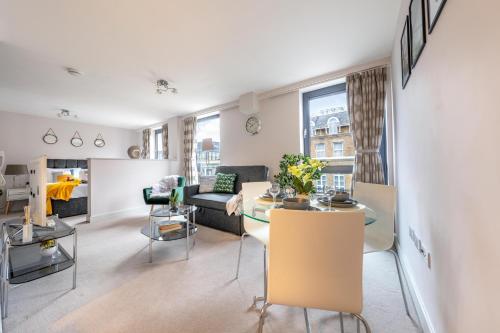 a living room with a couch and a table at Windsor Luxury Studio Apartment in Windsor