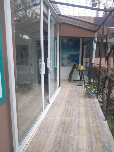 an empty porch with sliding glass doors on a house at Hotel Casa Ambrosia in Villeta