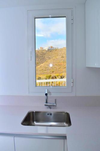 a sink in a kitchen with a window at SUNNY BEACH APARTMENT IN CALACEITE in Torrox Costa