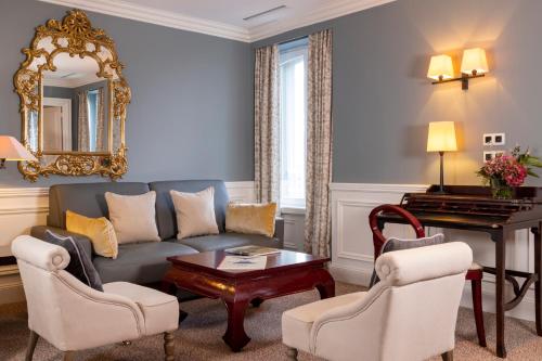 a living room with a couch and a table at Ermitage - Mont-Saint-Michel in Beauvoir