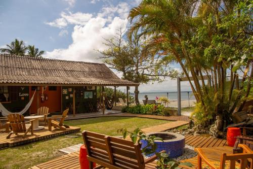 a house with a patio with a view of the ocean at Pousada Kainoa in Ilha do Mel