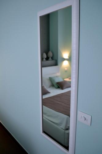 a mirror reflection of a bedroom with a bed in it at Gran Cancelliere B&B in Palermo