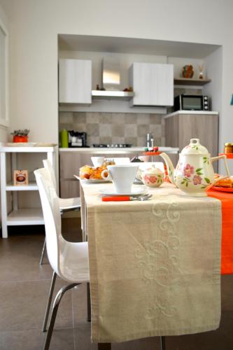 a kitchen with a table with a tea set on it at Gran Cancelliere B&B in Palermo