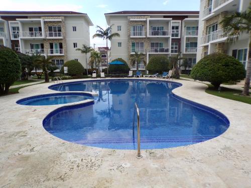 a large swimming pool in front of a building at Luxury in the Caribbean in Sosúa