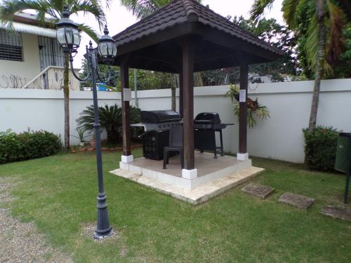 a gazebo with a grill and a street light at Luxury in the Caribbean in Sosúa