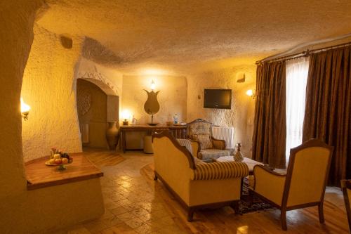 a living room with a couch and a table at Arif Cave Hotel in Goreme