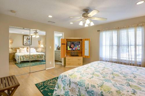 una camera da letto con un letto e una televisione di Cypress-n-Sun B-2 a Clearwater Beach