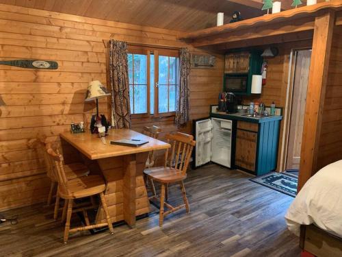 a kitchen with a table and chairs in a cabin at Honeybear Hideaway Cabin in Hayward