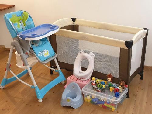 a bunk bed with a baby crib and a stroller at City Center Turu str apartments, parking, Tartu Home in Tartu