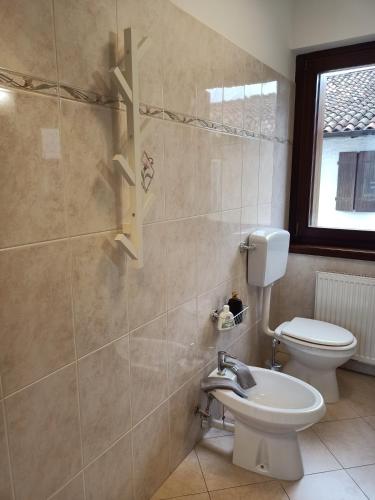 a bathroom with a toilet and a sink at Al Cristo in Cividale del Friuli