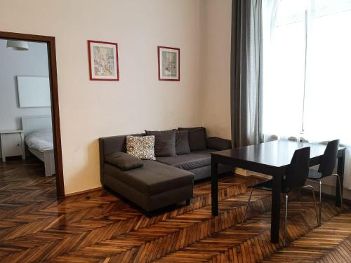 a living room with a couch and a table and a mirror at Apartment next to the Main Square in Krakow