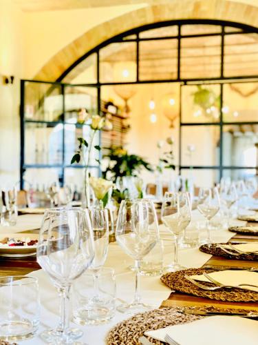 a table with wine glasses and plates on it at Casale Viridi - nel fresco delle colline Umbre in Narni