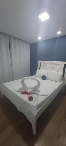 a bed in a room with a white mattress with at Meu cantinho na Serra- 5 Minutos de Itaipava in Petrópolis