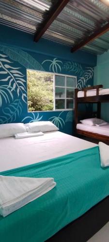 Ένα ή περισσότερα κρεβάτια σε δωμάτιο στο CasaLuna Tayrona