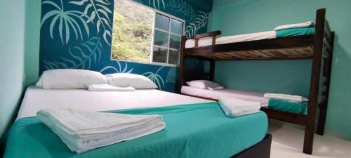 Ένα ή περισσότερα κρεβάτια σε δωμάτιο στο CasaLuna Tayrona