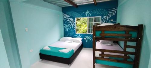 a bedroom with two bunk beds and a window at CasaLuna Tayrona in Santa Marta