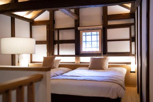 a bedroom with two beds and a window at Kamakura COCON in Kamakura