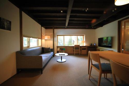 a living room with a couch and a table at Kamakura COCON in Kamakura