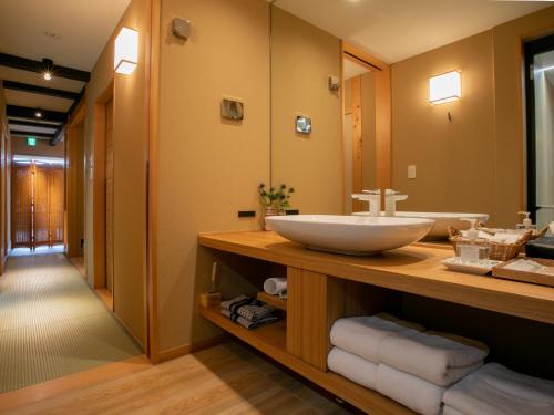 a bathroom with a sink and a mirror at Shirasagi Kyoto in Kyoto