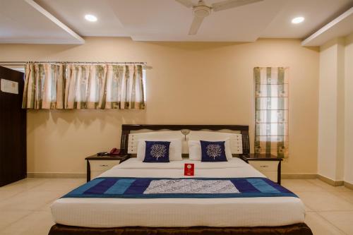 a bedroom with a large bed with blue pillows at Way Inns in Hyderabad