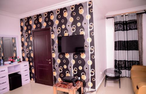 a living room with a black and gold patterned wall at executive 4bedrooms house in Lagos Nigeria in Lekki