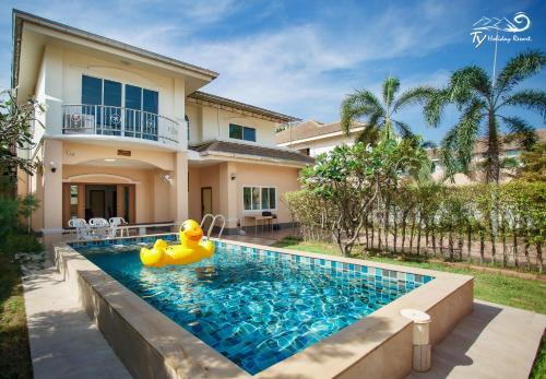 a pool with a rubber duck in front of a house at TY Holiday Resort in Pattaya