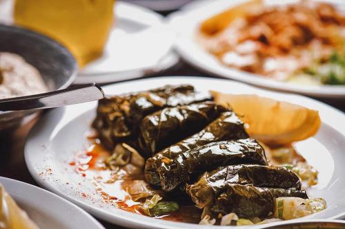 a plate of food on a table with plates of food at City Center Holiday room in Limassol