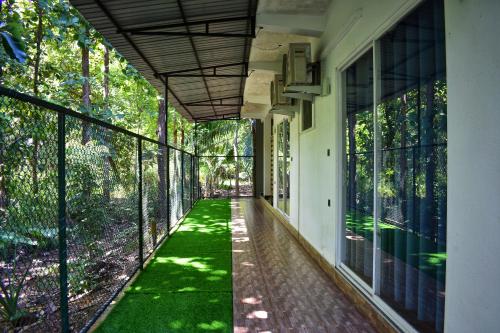 an empty hallway of a house with a walkway at Forest Edge Safari Villa in Udawalawe