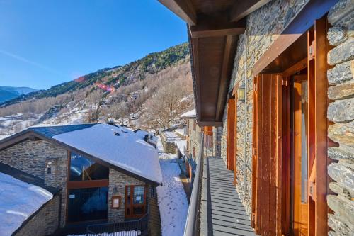 a balcony of a building with snow on the roof at Aparthotel Areu in Areu