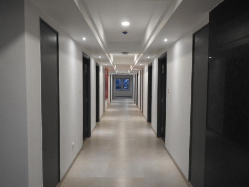 an empty corridor in a building with black and white walls at TGI Ameya Grand in Panaji