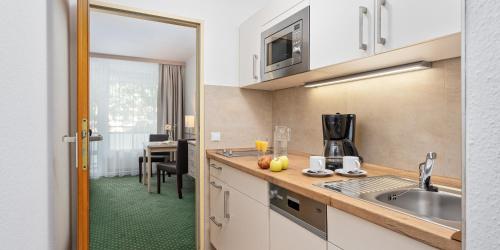 a kitchen with a sink and a counter at Appartementhaus Bavaria in Bad Füssing