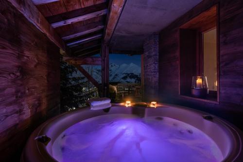 a large bath tub in a room with a window at Wanderful Life Les Arcs refuge haut de gamme in Arc 1600