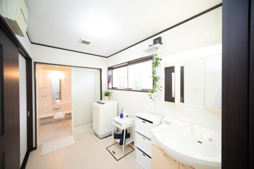 a bathroom with a sink and a mirror at Awaji Central Inn Kuruma713 in Awaji