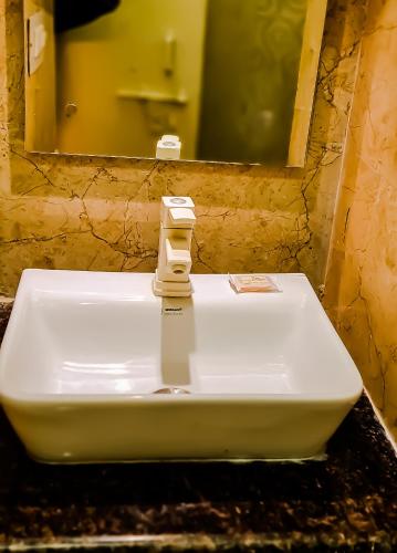 a white sink in a bathroom with a mirror at Hotel Kamal Nearest To Taj Mahal in Agra