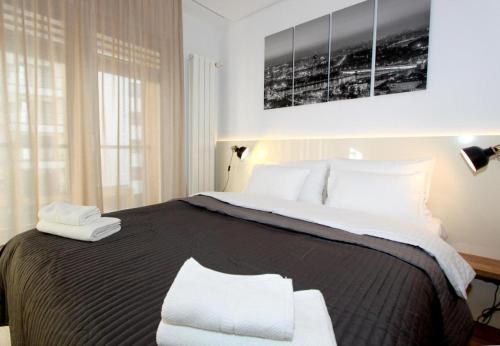 a bedroom with a large bed with white pillows at Apartment SUN CITY 2 in Belgrade