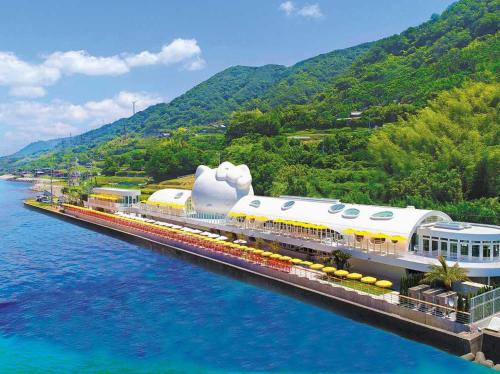 a train on a bridge over a body of water at Awaji Central Inn Kuruma713 in Awaji